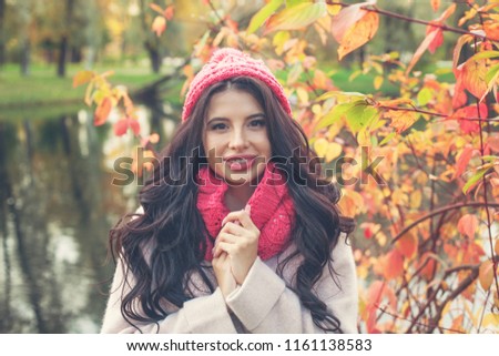 Beautiful happy woman on colorful autumn background outdoors