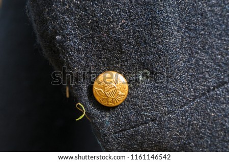 US button on military cloak close up