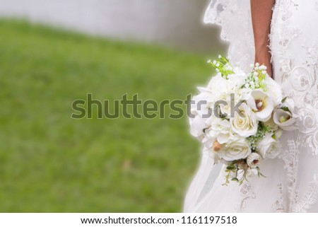 White flower bouquet in a hand of bride shows happiness and love of couple Royalty-Free Stock Photo #1161197518