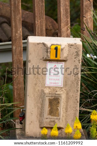 A front view of a small electricity box on the side of the road 