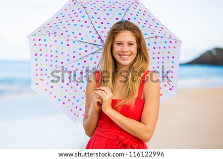 Beautiful Young Woman Walking on Tropical Beach with Colorful Umbrella