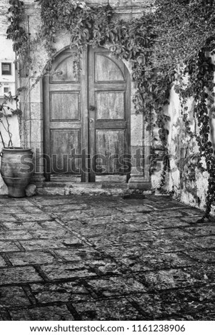 Old greek doorways in black and white, nostalgic images high in texture and detail.