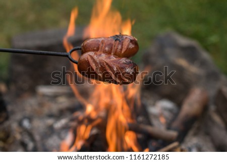 Open camp fire grilling spekacky sausage 