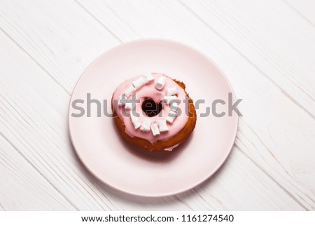 Pink donuts with marshmallows. Pink donut stock images. Donut on a Pink plate. Donut isolated on a Pink plate.