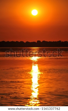 sunset in the Danube delta Romania.Beautiful blueish lights in water.Beautiful sunset landscape from the Danube Delta Biosphere Reserve in Romania