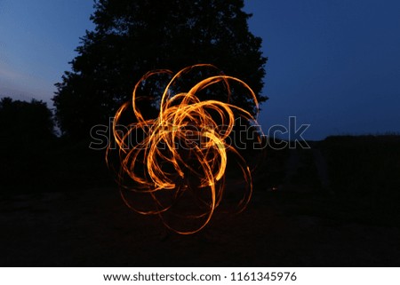an amazing fire performance, a fireshow performed by professional artists performing with burning objects at a city festival and a festival for human fun, a dangerous hobby, a bright show
