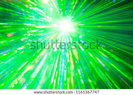 Green laser show rays at top nightlife party event performance. Luxury entertainment with bright light source and many beams and streams to every side at nightclub event, festival or New Year's Eve