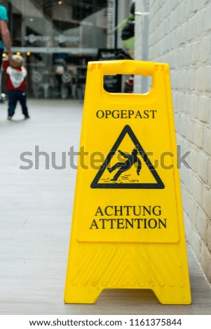 Warning Yellow plastic floor sign Opgepast/Achtung/Attention, slippery wet floor