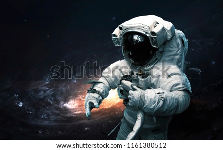 Astronaut against galaxy. Science fiction art. Elements of this image furnished by NASA