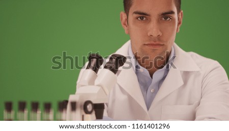 Portrait of Hispanic medical research scientist in laboratory on green screen