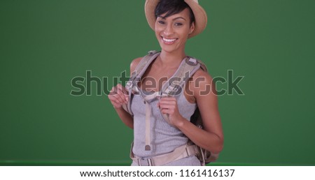 Happy smiling black woman backpacking on green screen