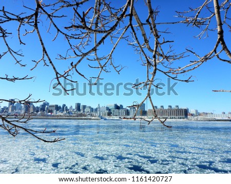 Montreal Cityscape in Winter - view from the Saint Helen Island . Ice on the Saint Lawrence River and blue sky