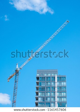 Crane. Construction crane. Huge crane against blue sky.
