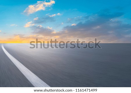 Empty asphalt road and natural landscape in the setting sun