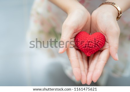 Red heart in hands from above. Healthy, love, donation organ, donor, hope and cardiology concept. Valentines day card.Giving love concept with hands holding a red heart. Royalty-Free Stock Photo #1161475621