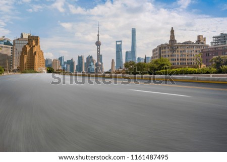 Empty asphalt road along modern commercial buildings in China