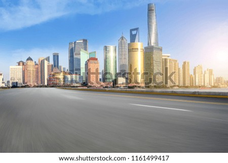 Empty asphalt road along modern commercial buildings in China
