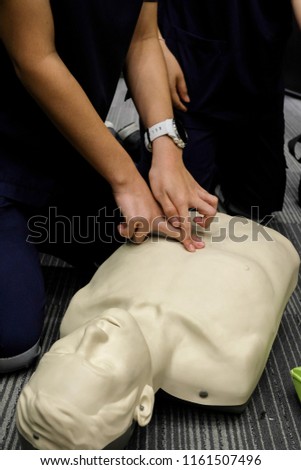 Vertical picture of CPR training with dummy use fingers find best point to cpr over epigastric