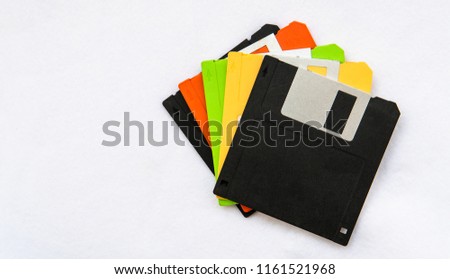 Colourful floppy disks on white background.