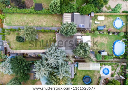 Aerial photo with the drone, a new build-up plot with single houses and gardens, narrow neighbourhood