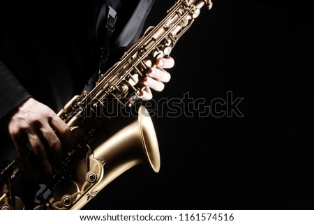 Saxophone player. Saxophonist playing jazz music instrument. Sax player hands Royalty-Free Stock Photo #1161574516