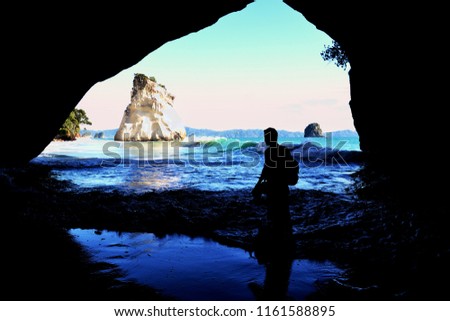 Cathedral cave shilouette man beach from cave