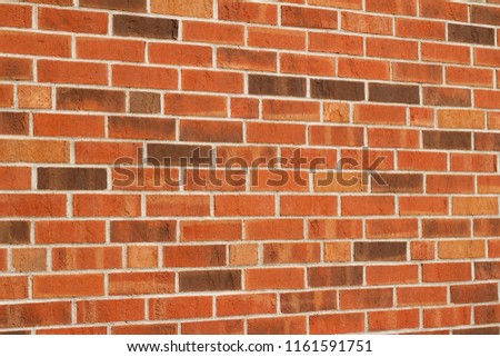 Colorful red and brown brick wall background in a Flemish stretcher bond pattern (angle view)
