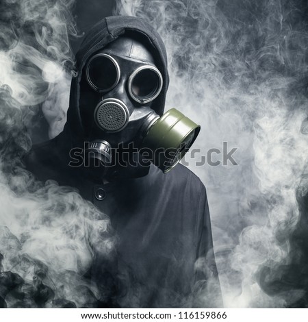A man in a gas mask in the smoke. black background Royalty-Free Stock Photo #116159866