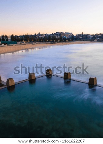 Long exposure view of Coogee Beach with the rock pool. Sydney, Australia