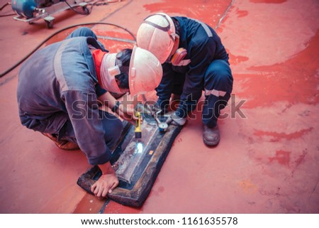 Male worker inspection vacuum test storage tank weld leak