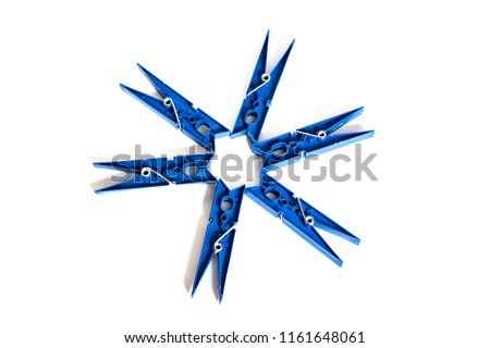 Blue clothespins stacked in a circle on a white background, isolated