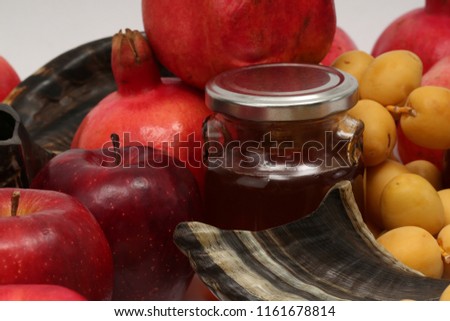 Rosh hashanah (jewish New Year holiday) concept signs: honey jar, honey dipper, shofar (horn), pomegranates,  apples, yellow dates. Traditional symbols of jewish holiday culture  on a white background