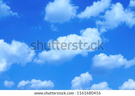 Small fluffy clouds against blue sky - a picture taken using  an artistic digital filter 
