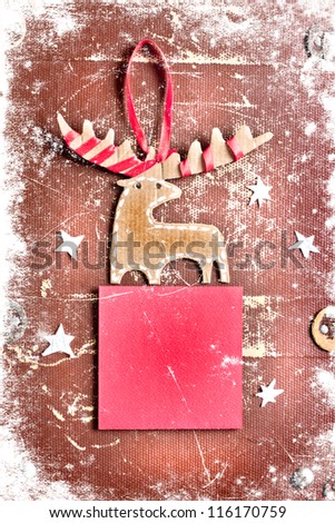 Christmas decoration over grunge paper background/old paper bordering with christmas decoration with a sign