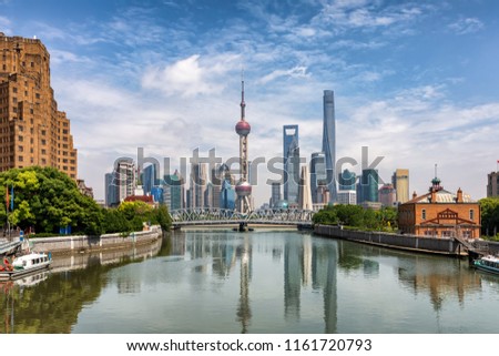 View to the urban skyline of Shanghai, China, with the historical Waibaidu bridge in front on a sunny day
