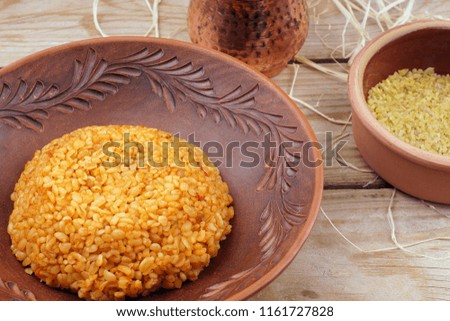 Croup of bulgur in boiled and raw form on a table