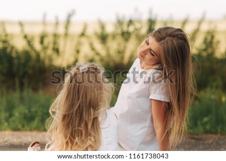 Beauty Mum and her Child playing in Park together. Outdoor Portrait of happy family.