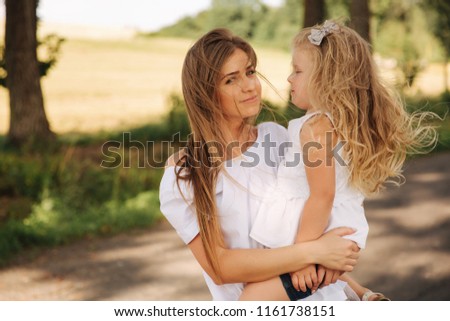 Little girl giving her mom a kiss