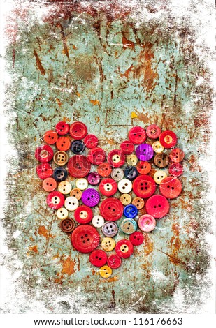 Red heart background on vintage old surface.Old colorful buttons/Valentines card