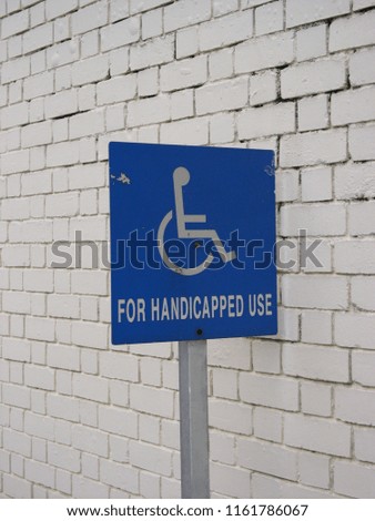 Accessible street sign with wheelchair logo.