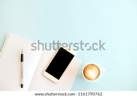 Minimalistic flat lay composition of black & white laptop computer keyboard, cell phone gadget, cup of coffee & folded glasses on textured wooden desk table background. Workspace top view, copy space