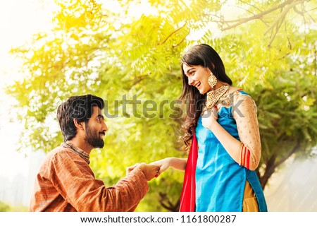 Indian man proposing to his bride Royalty-Free Stock Photo #1161800287