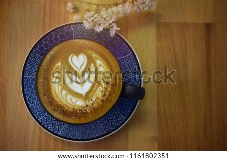 Good morning coffee ,  beautiful milk foam decoration in a cup of cappuccino,top view and close up, some space for wording