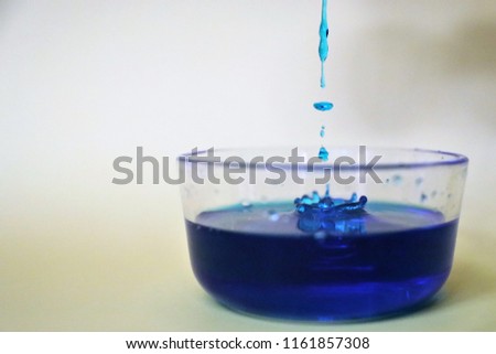 Water dripping into a large blue bowl.