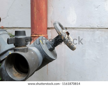 old angle fire hose gate valve connector red pipe building white wall background
