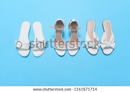 Three Womens, leather, white high hell shoes on blue background
