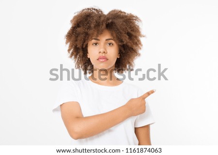 Young african american happy woman showing copyspace pointing on isolated white background. Summer fun. Template, blank shirt. Afro curly hairstyle.
