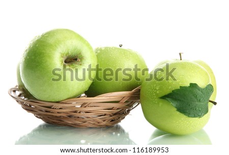 Ripe green apples with leaves in basket isolated on white