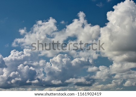 Horizontal image of dramatic clouds with bright blue sky in background