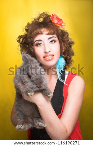 Young woman in bright cloth with grey rabbit